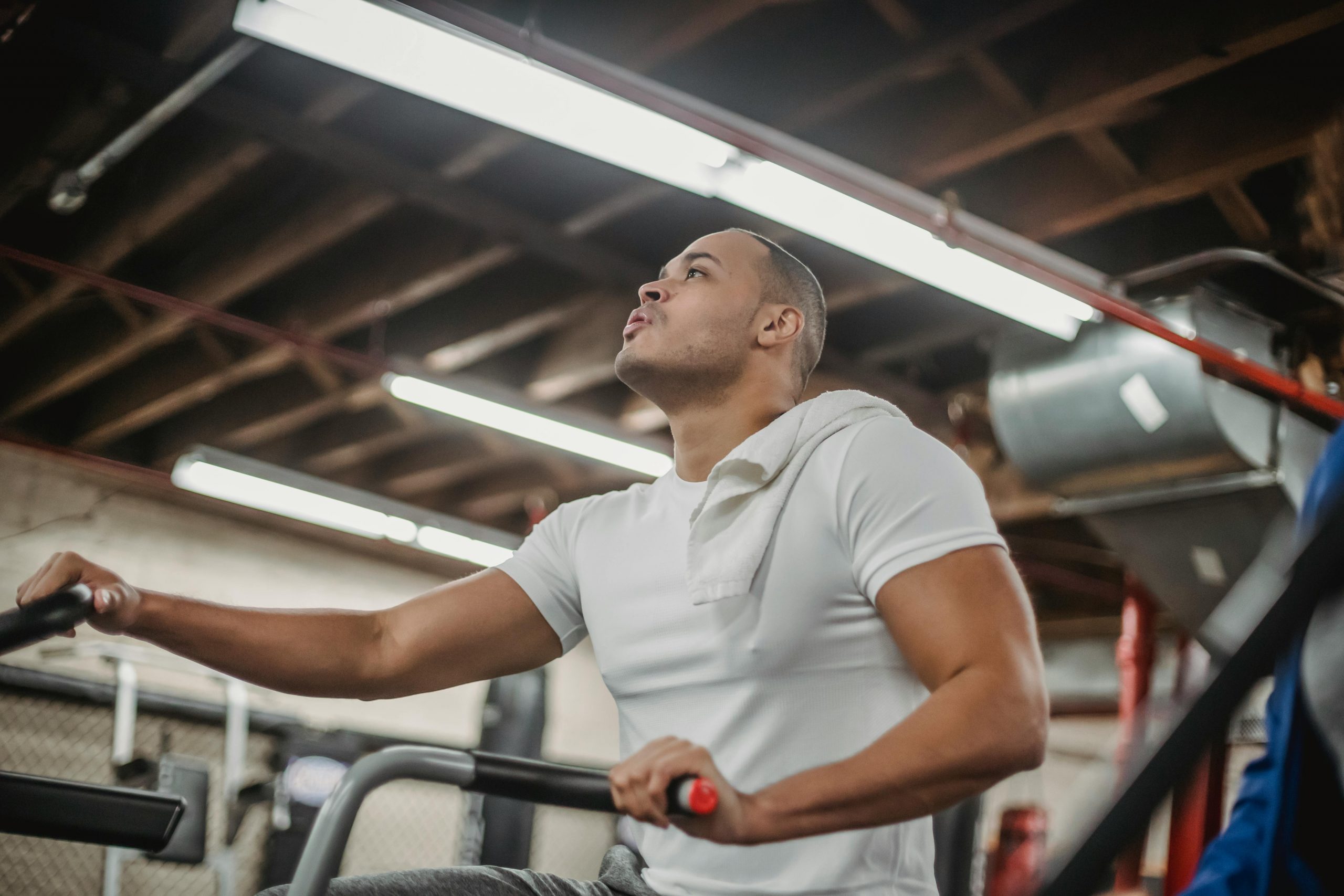 man using a stationary bicycle in a gym